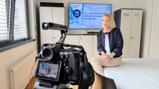UTS-Mitarbeiterin vor einer Kamera
